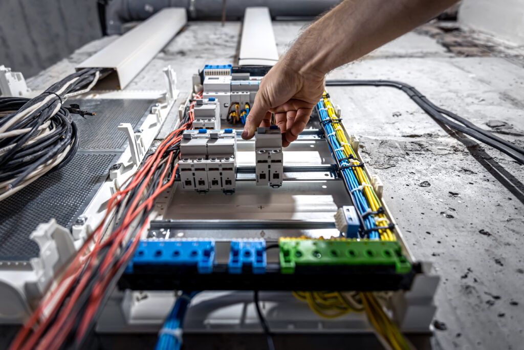 Voltage switchboard with circuit breakers are in the ON and OF positions in the big electric box for electrical distribution panel, and temporary electric cables are switched.