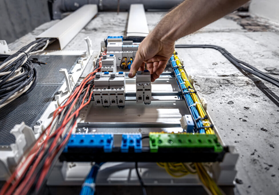 Voltage switchboard with circuit breakers are in the ON and OF positions in the big electric box for electrical distribution panel, and temporary electric cables are switched.